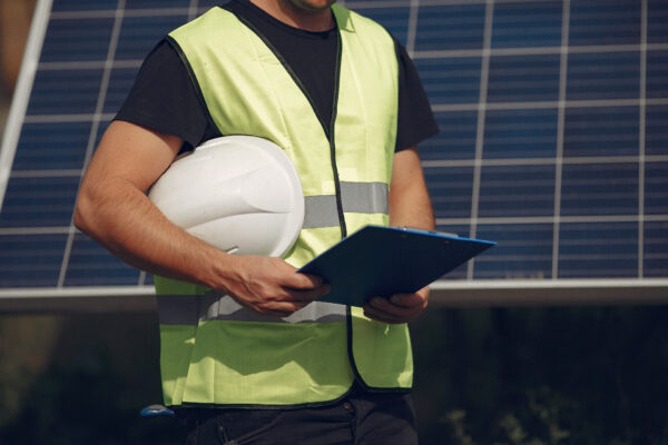 Services-Man in a white helmet near a solar panel